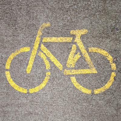 A bicycle painted on a bike lane, the picture the code beside it was made from
